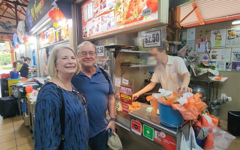 Travelers visiting a heritage Michelin hawker on a Singapore Private Street Food Tour